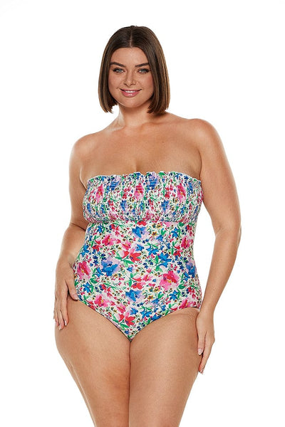 In studio image of curvy plus size women wearing cute shirred strapless bandeau one piece
