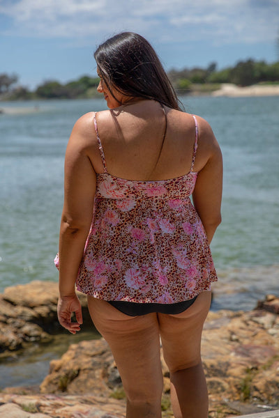 Plus size model wearing strapless underwire swim bandeau in leopard and floral print