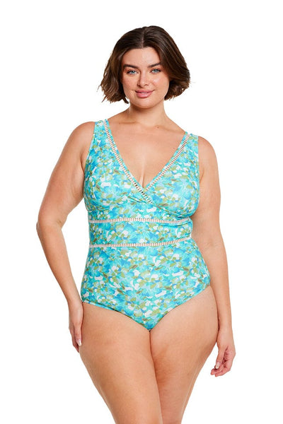 brunette model wears plus size plunge v neck one piece swimsuit in blue