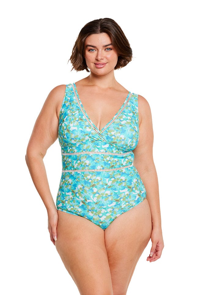 brunette model wears plus size plunge v neck one piece swimsuit in blue