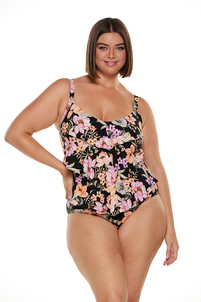 Brunette women wears flattering 3 tier tummy control one piece swimwsuit