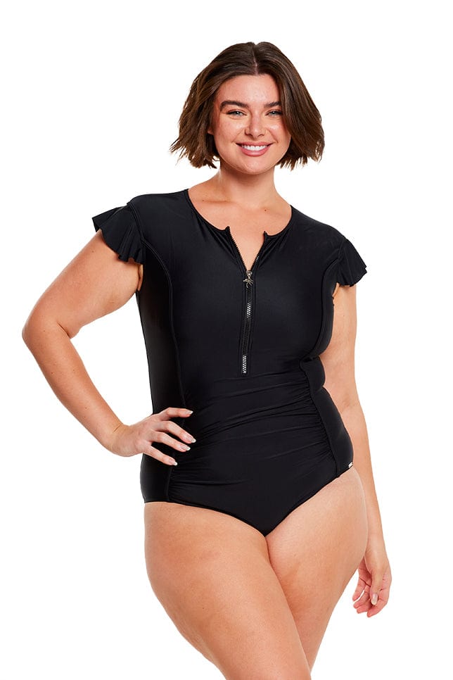 brunette plus size model wears plain black one piece with front zip and frill sleeves