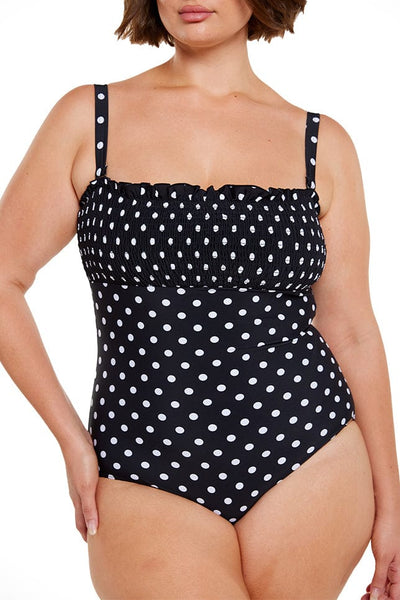 Brunette plus size women wears black and white dots strapless bandeau one piece swimsuit
