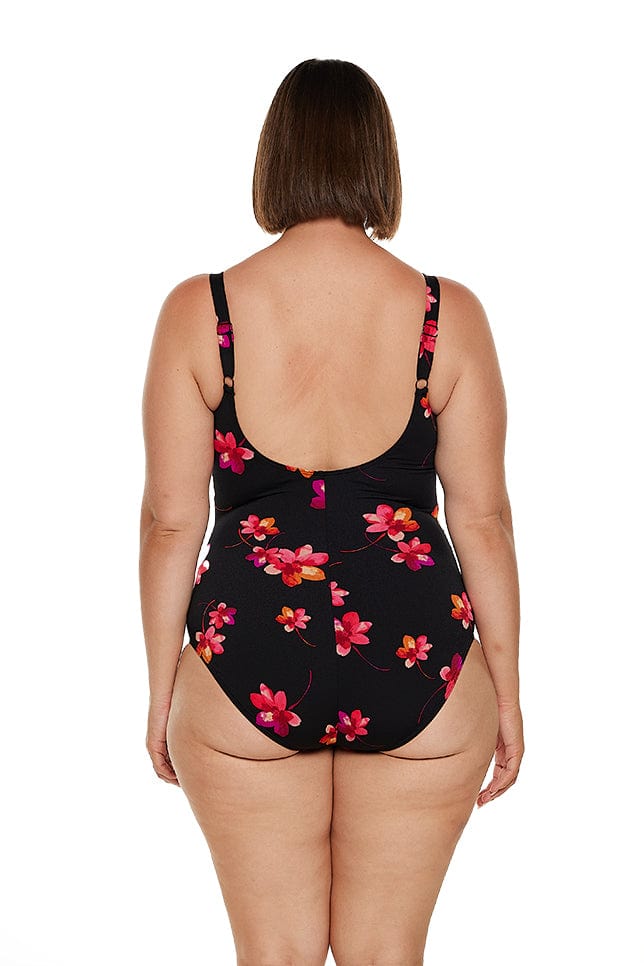 Brunette model wears chlorine resistant pink floral one piece with scoop back