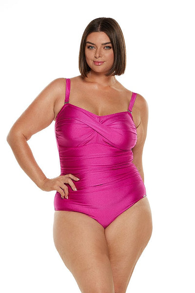 Brunette model wears hot pink twist front bandeau one piece with shelf bra and removable straps