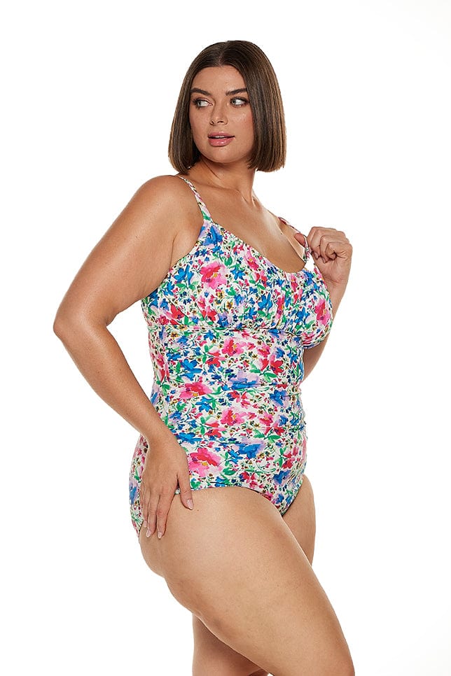 brunette model wears underwire ruched one piece with adjustable straps