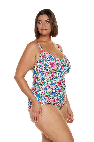 Brunette curve model wearing supportive underwire tankini top in floral print