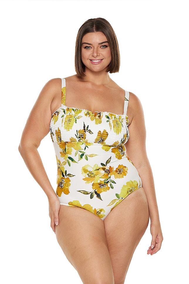 Brunette model wears flattering yellow strapless bandeau one piece with removable straps