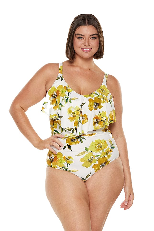 Brunette model wearing curvy yellow floral swimsuit with frill v neck