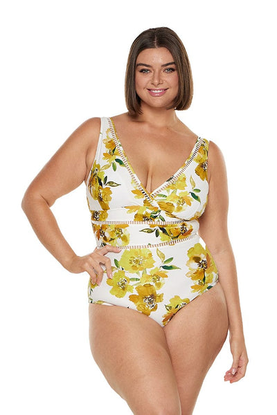 Brunette model wears yellow floral v neck one piece swimwear