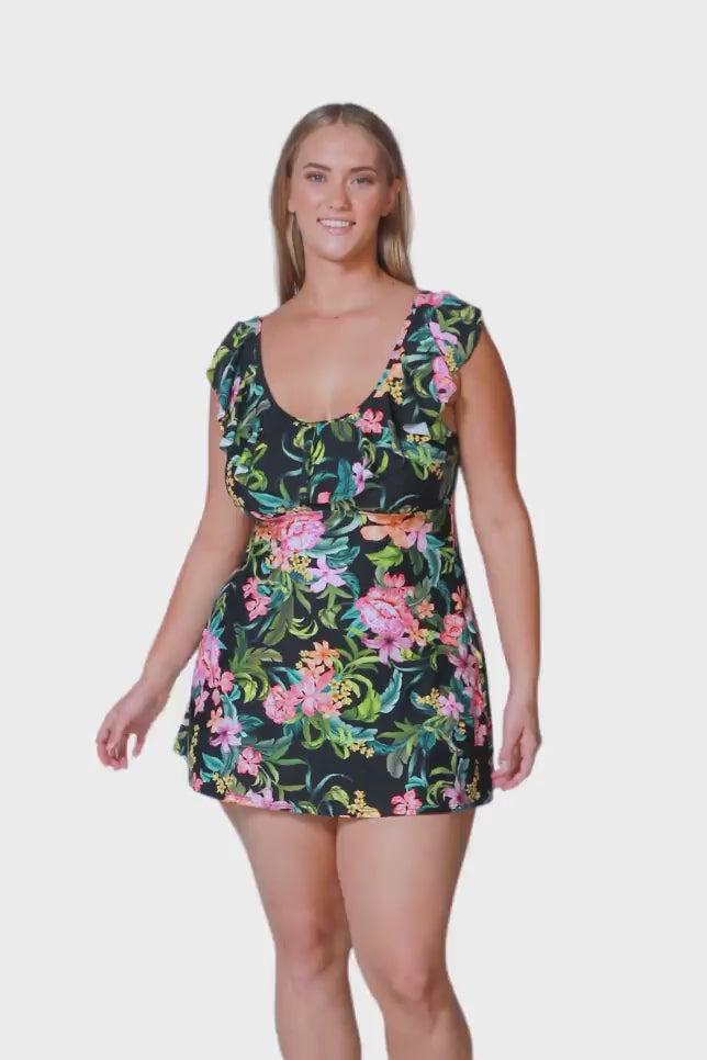 blonde plus size model wears cute tropical floral swim dress with front frill detail