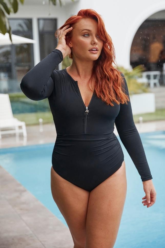 model wearing long sleeve black swimsuit