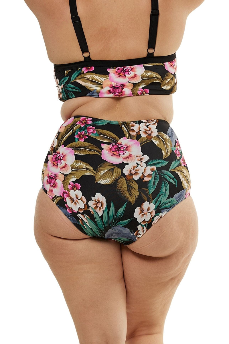 Model facing back wearing tropical printed high waisted bikini pant
