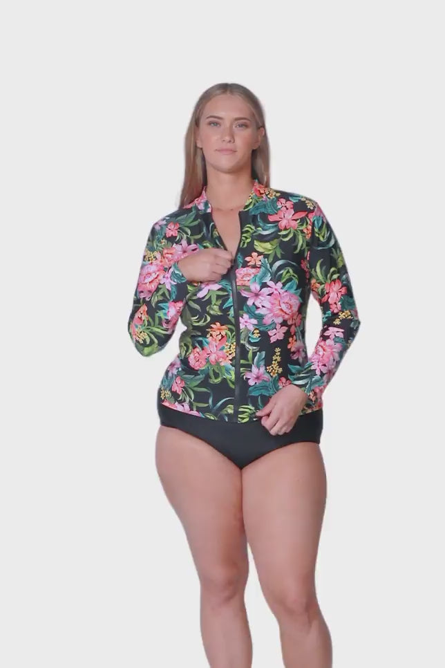 plus size blonde model wearing tropical floral long sleeve rash vest with front zip