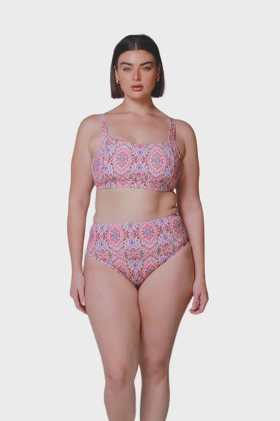 brunette model wearing high rise high waisted pink bohemian swimming bottom