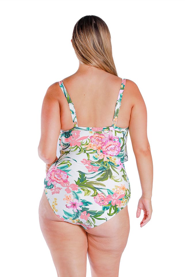 blonde women wears white floral one piece swimsuit with adjustable straps