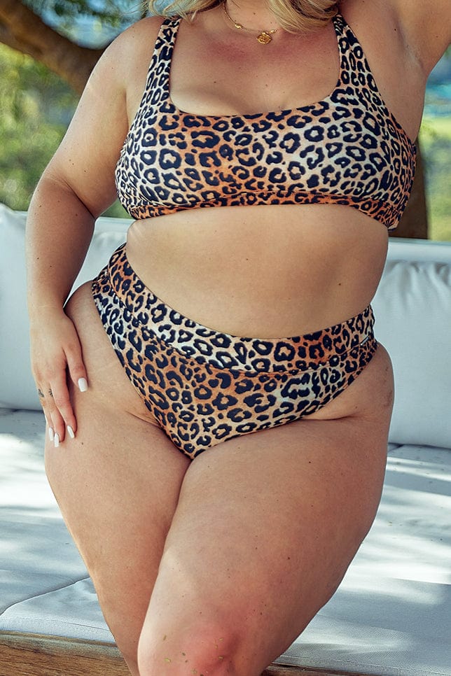 blonde plus size model wears leopard print high cut high waisted bikini bottoms