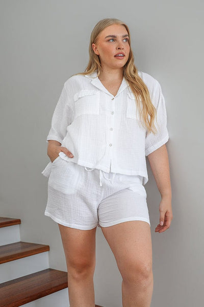 blonde plus size women wearing a short set of crepe loungewear in her home