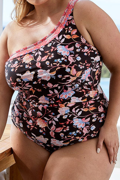 plus size blonde model wears pink floral one piece with one shoulder